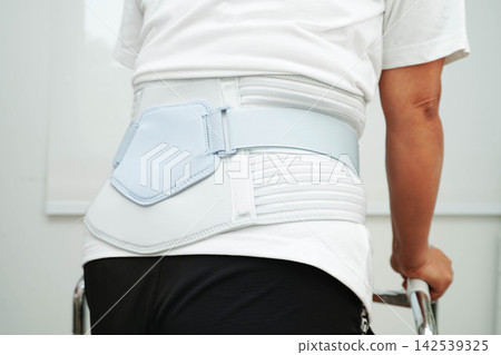 Asian senior pain back wearing elastic support belt with walker. Asian senior pain back wearing elastic support belt with walker. 142539325