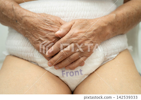 Asian senior woman patient wearing adult incontinence diaper pad in hospital. Asian senior woman patient wearing adult incontinence diaper pad in hospital. 142539333