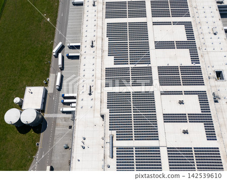 Aerial view of a modern logistics center with solar panels on the roof Aerial view of a modern logistics center with solar panels on the roof 142539610
