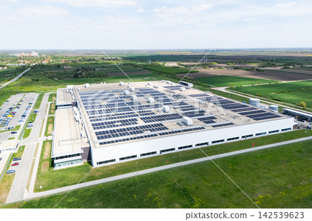 Aerial view of a modern logistics center with solar panels on the roof Aerial view of a modern logistics center with solar panels on the roof 142539623
