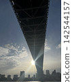A sunset over Tokyo Bay viewed from beneath the bridge. 142544157