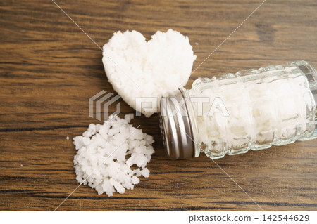 Sodium chloride sea salt with salt shaker. Sodium chloride sea salt with salt shaker. 142544629