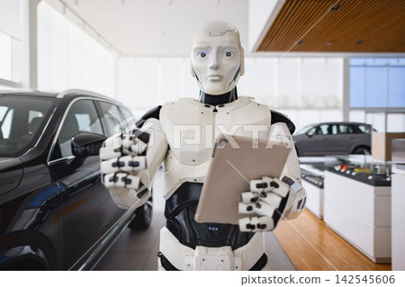 A humanoid robot stands in a car dealership holding a tablet and offering a car key, symbolizing future automotive sales A humanoid robot stands in a car dealership holding a tablet and offering a car key, symbolizing future automotive sales 142545606