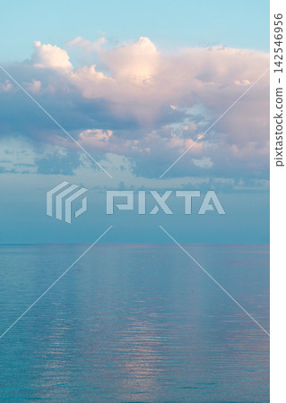 Pastel Clouds Reflected Over Calm Blue Sea Pastel Clouds Reflected Over Calm Blue Sea 142546956