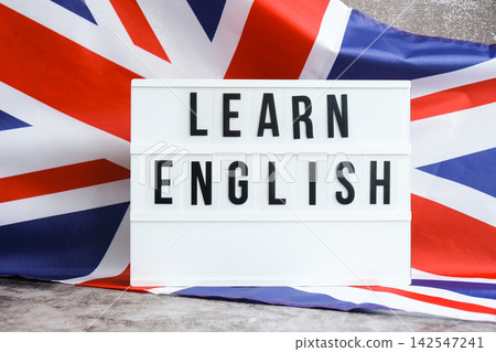 Message LEARN ENGLISH on background of Great Britain UK flag made from silk. British national flag with concept of tourism and traveling students opportunities scholarship programs Message LEARN ENGLISH on background of Great Britain UK flag made from silk. British national flag with concept of tourism and traveling students opportunities scholarship programs 142547241