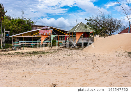 Soure, Brazil - Dec 10, 2025: Colorful waters and natural-framed kiosks at Pesqueiro Beach, Soure in Marajo, Brazil 142547760