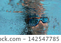 Young girl swimming underwater with air bubbles 142547785
