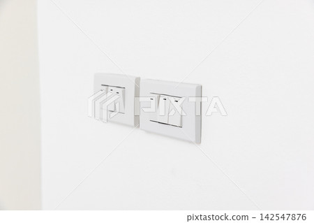 Triple lighting switch on white concrete wall Triple lighting switch on white concrete wall 142547876