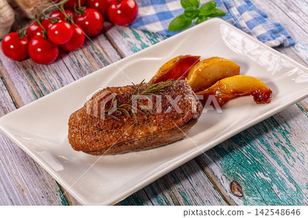Seared duck breast with caramelized pear slices on white plate Seared duck breast with caramelized pear slices on white plate 142548646