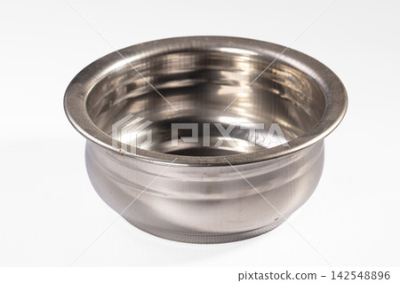 Empty stainless steel bowl on white background, reflective surface, shallow depth of field 142548896
