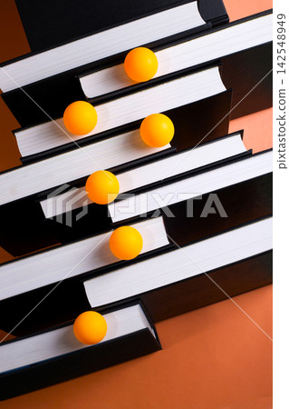A backdrop of stacked books on a colored background with colorful balls. A backdrop of stacked books on a colored background with colorful balls. 142548949