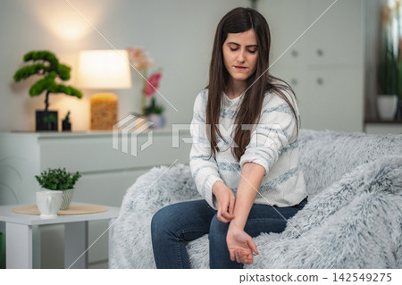 Woman scratching arm feeling discomfort from skin allergy Woman scratching arm feeling discomfort from skin allergy 142549275