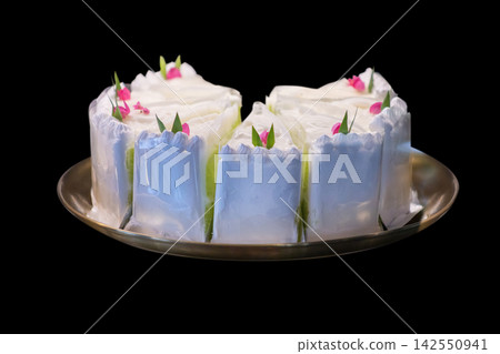 Die cut of Delicious homemade coconut chiffon cake, on black isolated Die cut of Delicious homemade coconut chiffon cake, on black isolated 142550941