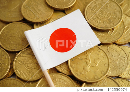 Japan flag on coin and banknote money, finance trading investment business currency. Japan flag on coin and banknote money, finance trading investment business currency. 142550974