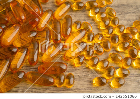 Fish oil or Cod liver oil gel in capsules with omega 3 vitamins, supplementary healthy food. Fish oil or Cod liver oil gel in capsules with omega 3 vitamins, supplementary healthy food. 142551060
