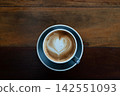 cappuccino on wooden table in top view 142551093