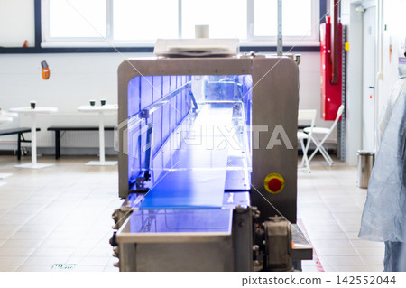 Freezing automated conveyor machine with blue belt at sweets factory Freezing automated conveyor machine with blue belt at sweets factory 142552044