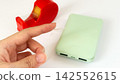 Insulate the USB port of the swollen mobile battery with tape. 142552615