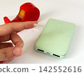 Insulate the USB port of the swollen mobile battery with tape. 142552616