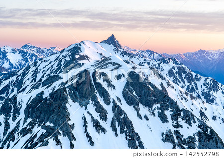 Early morning view of Mt. Yarigatake from Kitahotaka Hut (magic hour) - Climbing Mt. Kitahotaka in the Northern Alps during early summer when snow remains. Early morning view of Mt. Yarigatake from Kitahotaka Hut (magic hour) - Climbing Mt. Kitahotaka in the Northern Alps during early summer when snow remains. 142552798