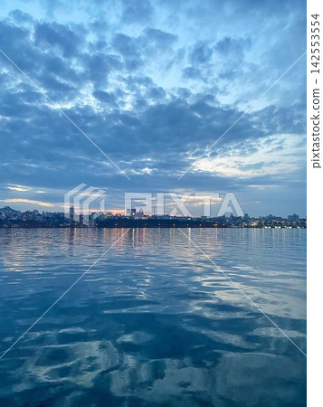Blue Hour City Skyline Reflected on Calm River Blue Hour City Skyline Reflected on Calm River 142553554