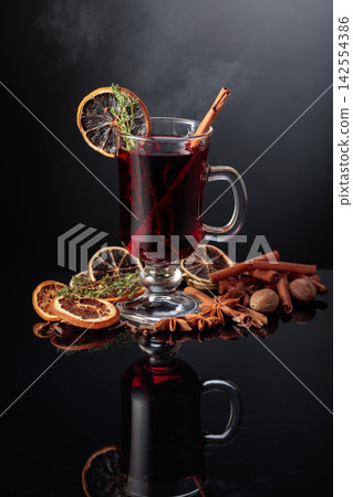 Mulled wine with spices on a black background. Mulled wine with spices on a black background. 142554386