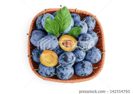 fresh blue plum in wicker basket isolated on white background. Top view. Flat lay fresh blue plum in wicker basket isolated on white background. Top view. Flat lay 142554793