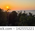 Beautiful Mediterranean sea sunset with coastal villas and palm tree 142555221