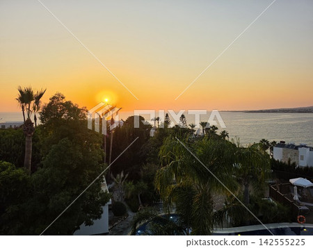 Beautiful Mediterranean sea sunset with coastal villas and palm tree 142555225