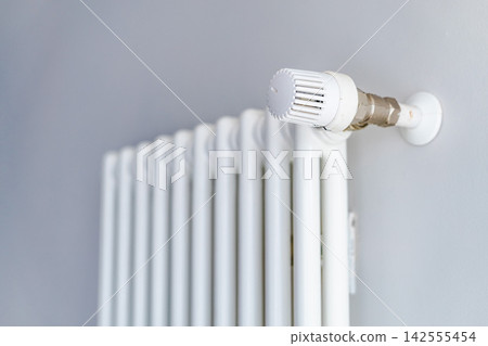 Close-Up of White Radiator with Thermostatic Valve Close-Up of White Radiator with Thermostatic Valve 142555454
