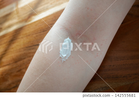 Skincare like help for the skin with acne or dermatitis. Hand of girl apply the moisturizing cream on her body in bathroom. Bodycare every day. Skincare like help for the skin with acne or dermatitis. Hand of girl apply the moisturizing cream on her body in bathroom. Bodycare every day. 142555681