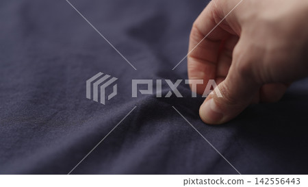 man hand checking blue cotton shirt cloth man hand checking blue cotton shirt cloth 142556443