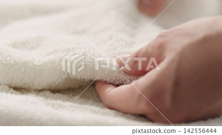closeup shot of man touching white cotton terry towel closeup shot of man touching white cotton terry towel 142556444