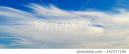 delicate cirrus clouds spread across the high blue sky delicate cirrus clouds spread across the high blue sky 142557194