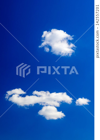 several fluffy cumulus clouds of different sizes in the blue sky several fluffy cumulus clouds of different sizes in the blue sky 142557201