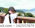 A young elementary school girl gazing at the lake A young elementary school girl gazing at the lake 142557879