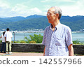 Senior man gazing at the lake Senior man gazing at the lake 142557966