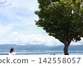 Woman looking at the lake Woman looking at the lake 142558057