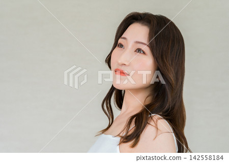 A beauty portrait of a woman in her 40s, showcasing her beautiful and radiant skin. A beauty portrait of a woman in her 40s, showcasing her beautiful and radiant skin. 142558184