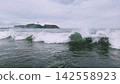 Enoshima Island and waves crashing against the Shonan coast under a cloudy sky. 142558923