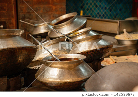 Metal pots lined up in the kitchen Metal pots lined up in the kitchen 142559672