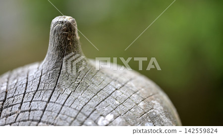 A close-up of the wooden finial of an ancient temple, bearing the marks of time. A close-up of the wooden finial of an ancient temple, bearing the marks of time. 142559824