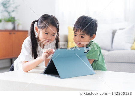Children studying at home using tablets Children studying at home using tablets 142560128