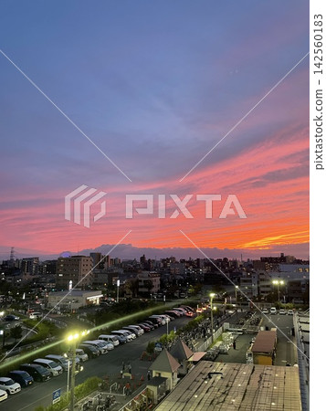 The town is bathed in the red light of the setting sun. The town is bathed in the red light of the setting sun. 142560183