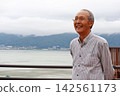 Senior man gazing at the lake Senior man gazing at the lake 142561173
