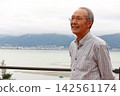 Senior man gazing at the lake Senior man gazing at the lake 142561174