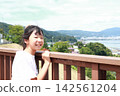 A young elementary school girl gazing at the lake A young elementary school girl gazing at the lake 142561204
