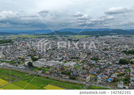 An aerial photograph capturing the city and mountain range of Iga City, Mie Prefecture. 142562191
