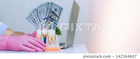 dentistry and medical insurance illustrated by a doctor counting dollars next to a tooth implant model. dentistry and medical insurance illustrated by a doctor counting dollars next to a tooth implant model. 142564687