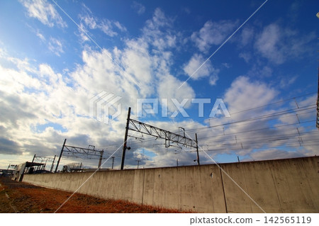Spreading clouds and power lines at the train depot Spreading clouds and power lines at the train depot 142565119